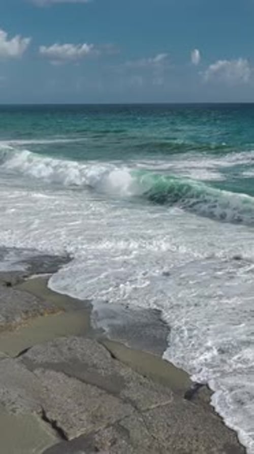 Vertical Video Mediterranean Storm With Turquoise Waves Hitting the Coastline