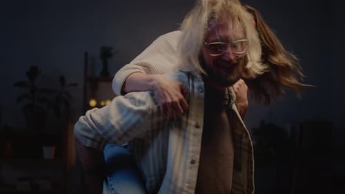 Smiling Woman Rides Man's Back in Home