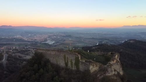 Aerial view historic and medieval castle ruins on a cliff at sunset