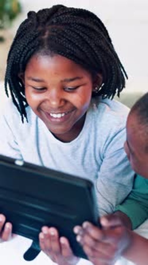 Children Looking at Tablet and Smiling