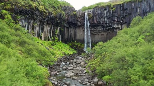 Svartifoss Basalt Waterfall In Iceland - aerial drone shot