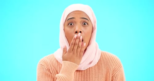 Woman Covers Mouth in Shock, Headscarf