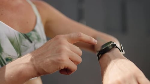 Redhead Female Athlete Checks Fitness Smart Watch in Sunny Tropical Outdoor Gym Professional