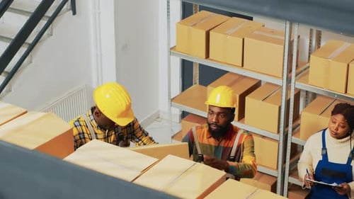 Warehouse Workers Organize Shipping Boxes