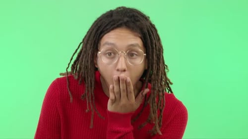 Wow, shock and surprise with a black man in studio on a green screen background showing disbelief