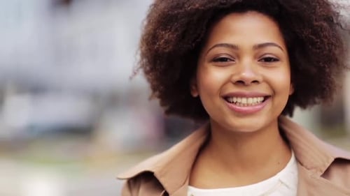 Smiling Young Woman Outside Wearing Brown Coat