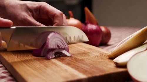 Slicing Red Onion on Wooden Cutting Board