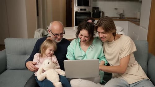 Family Together Using Laptop at Home