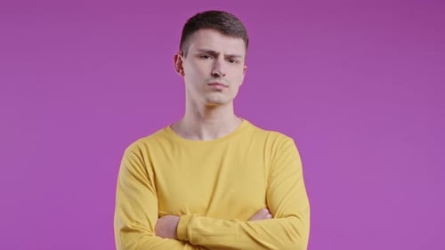 Annoyed Man Posing with Arms Folded