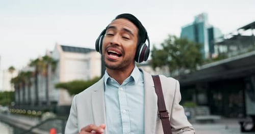 Man in Suit Listens to Music in City