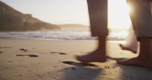 Couple, beach and footprints on sand for walk, care support and relax wellness on weekend adventure