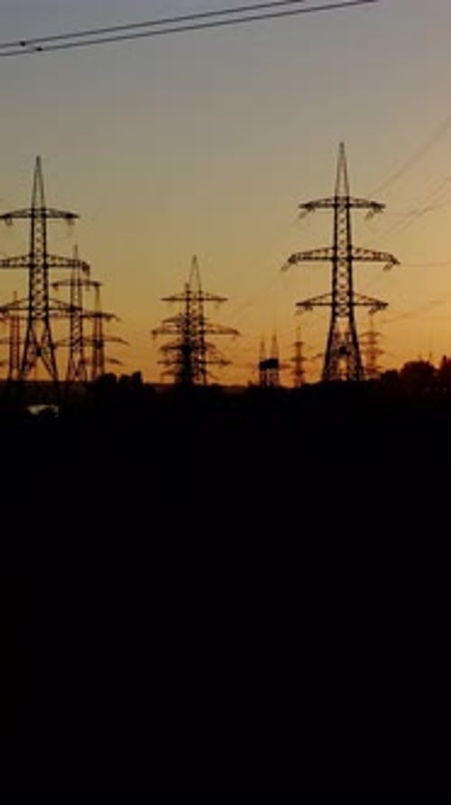 High voltage post at sunset. High voltage towers with electrical wires. Vertical video