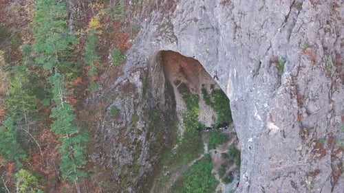 Man Climbing Steep Cliff