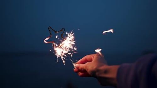 One carefree millennial girl students hang out on nature with sparklers