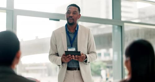 Man Giving Corporate Presentation with Tablet