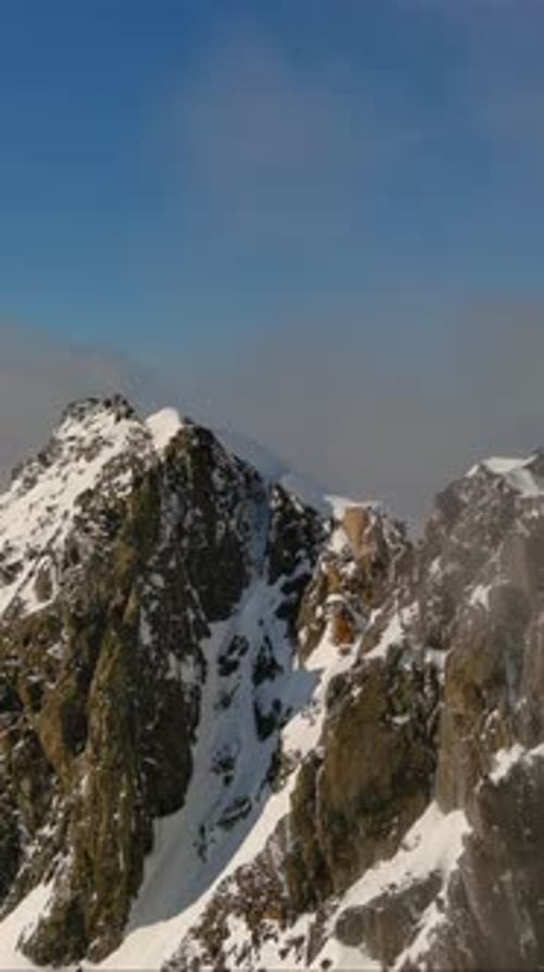 Snow Capped Mountain Peaks Above The Clouds. British Columbia, Canada.