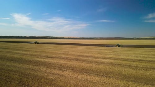 Tractors plowing the field in Ukraine