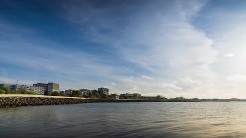 Embankment with Stones Passes Over the Black Sea Against the Backdrop of a Sunny Sky