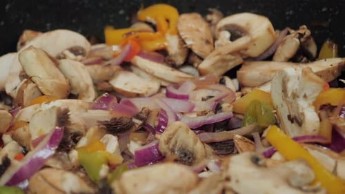 Vibrant Vegetables: Mushrooms, Onions, and Bell Peppers Cooking
