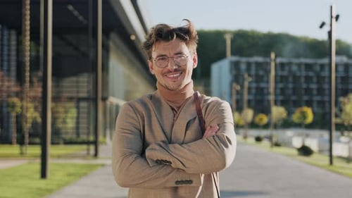Smiling Man Poses in Tan Suit Outdoors
