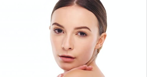 4k video footage of a beautiful young woman posing against a studio background