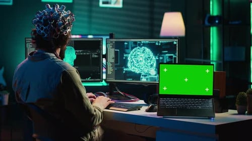 IT Admin Coding and Using EEG Headset to Upload Brain Into Green Screen Laptop