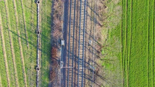 Aerial Bird's Eye View of Railway Tracks Between Rural Fields