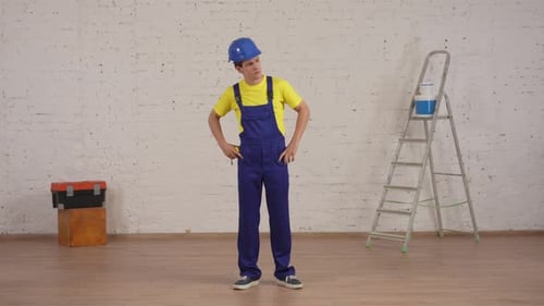 Full Length Video of a Young Construction Foreman Looking at the Room Under Renovation Unfolding the