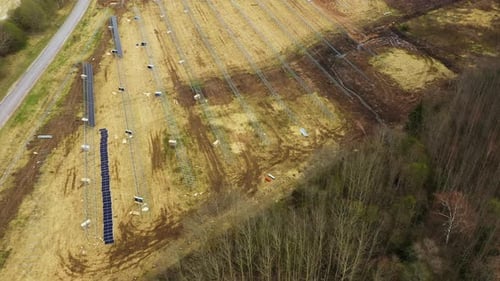 Panoramic aerial overview of metal frames for solar panels at energy site