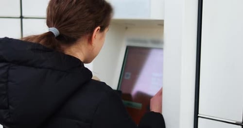 Brunette Woman Fills Out Data on Interactive Display of Parcel Terminal
