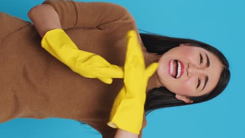Vertical Video Asian Homemaker Doing Time Out Gesture During House Cleaning in Studio
