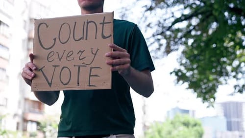 Close Up Protester Guy with Sign in His Hands Presidential Elections Election Campaign Bribery