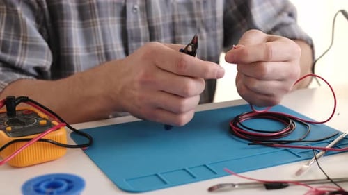 Person Soldering Wires Close Up In Workplace