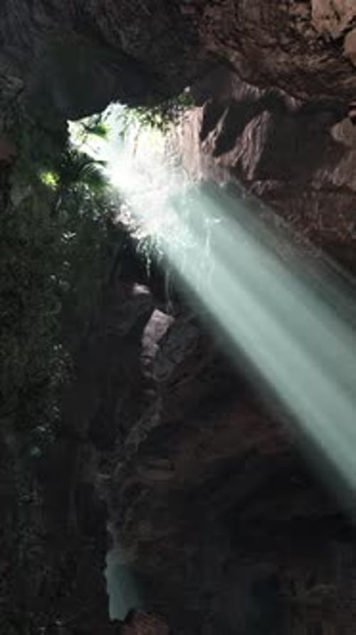 A Mesmerizing Beam of Light Illuminating a Mysterious Cave