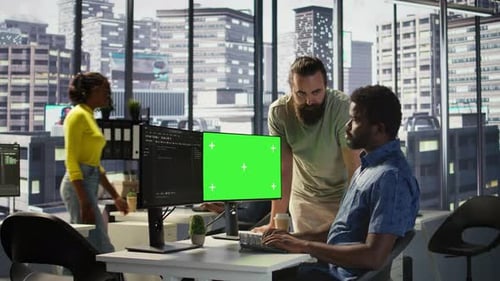 Team of IT Workers Using Green Screen Computer