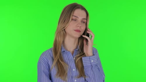 Young Woman Talking on phone on Green Background