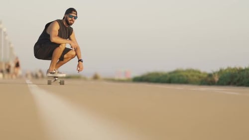 Adult Attractive Bearded Man Skateboarding on the Street