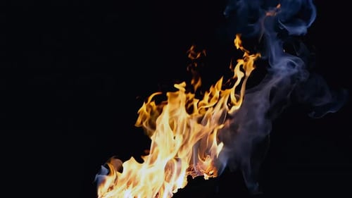 Intense Flames and Smoke Against Black Background