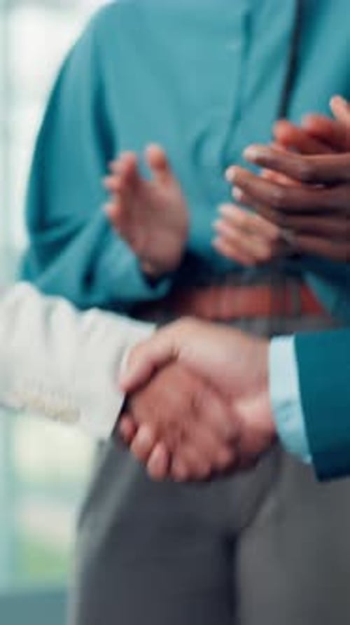 Business People Shake Hands at the Workplace