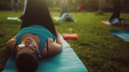 Close up senior woman doing workout activity with a group of friends in a public park