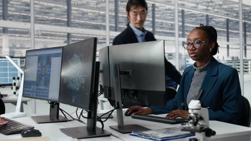Senior Manager and Woman Using AI to Optimize Microchip Production
