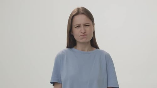 Video of an Annoyed Woman Looking at the Camera and Shrugging Her Shoulders Closeup Studio Shot
