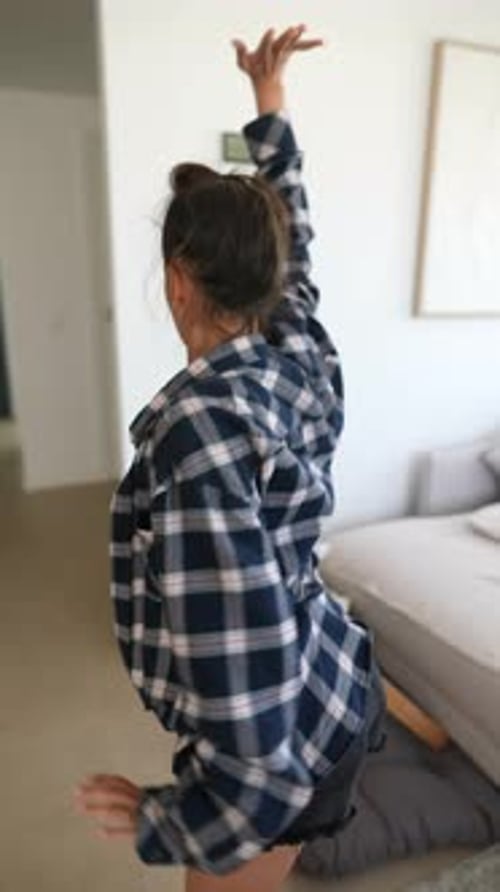 Young Woman Dancing Barefoot in Apartment