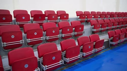 foldable red plastic audience chairs in indoor gym