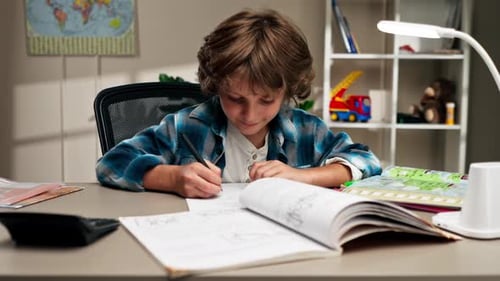 Boy Doing Homework at Desk Indoors