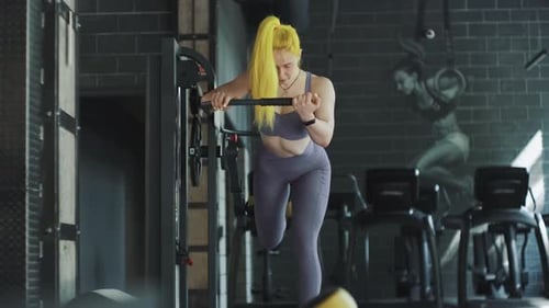 Gorgeous Female Professional Bodybuilder Doing Workout Exercises in Gym