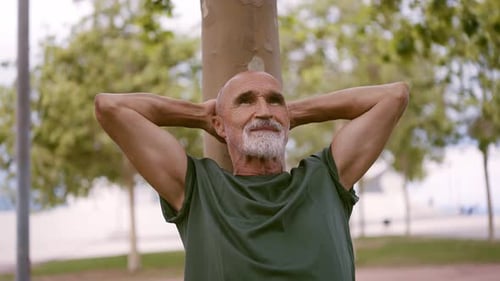 Senior Man Relaxing After Exercise in Urban Park