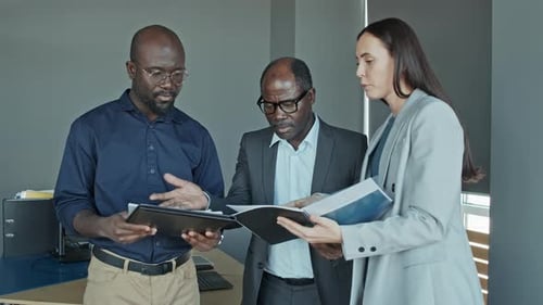 Coworkers Speaking with Boss Standing Together with Reports in Hands