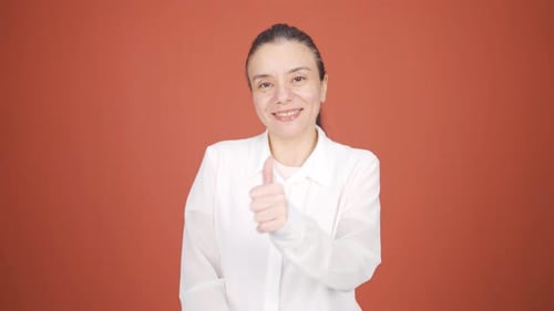 Woman Smiles and Gives Thumbs Up