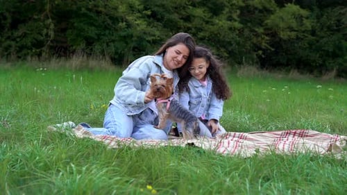 Happy Family Having Picnic in the Park Enjoying Summer and Nature Cheerful Mom Cuddling Her Little